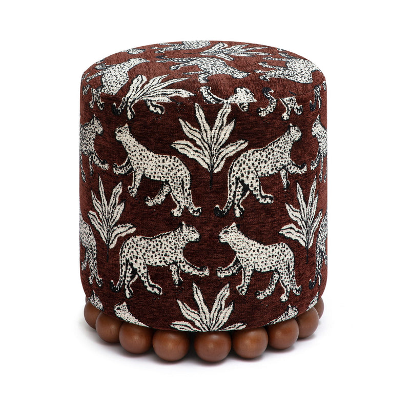 Dark brown animal-print ottoman with dark wood ball base; round cushioned top.