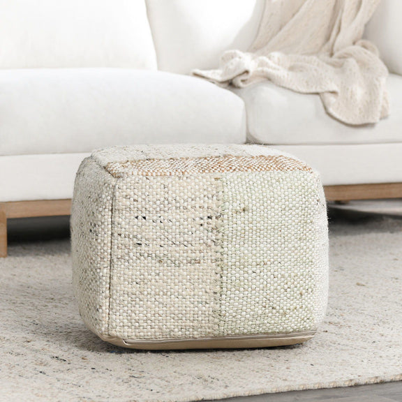 Low round pouf ottoman in light textured woven fabric with stitched edge detailing