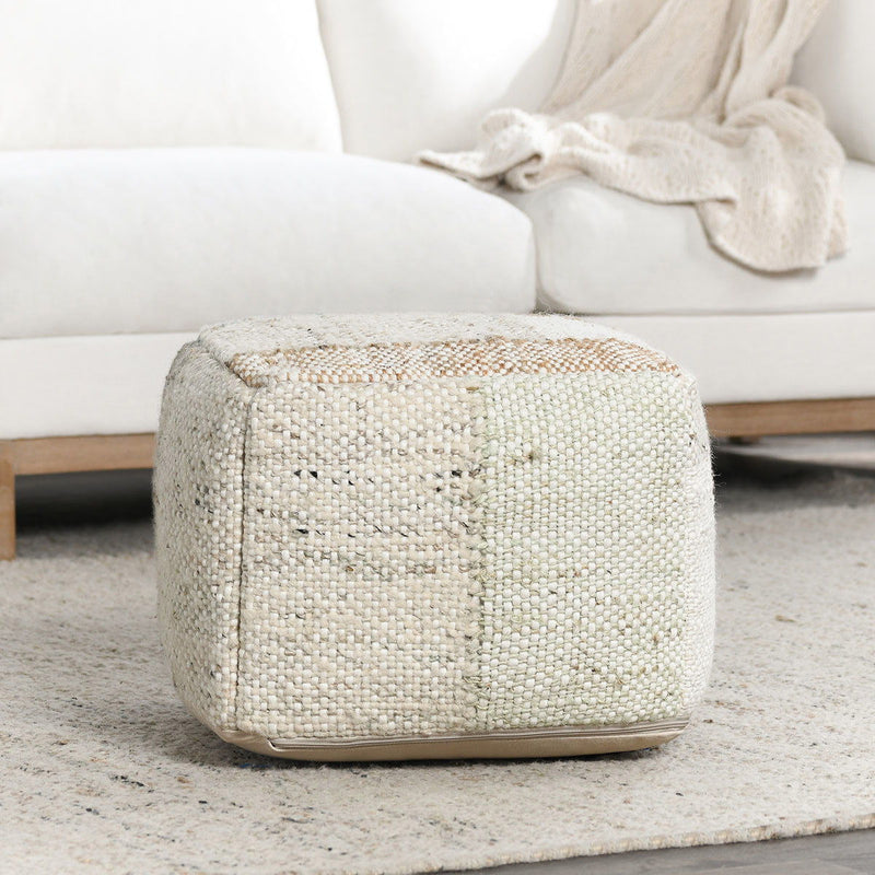 Low round pouf ottoman in light textured woven fabric with stitched edge detailing