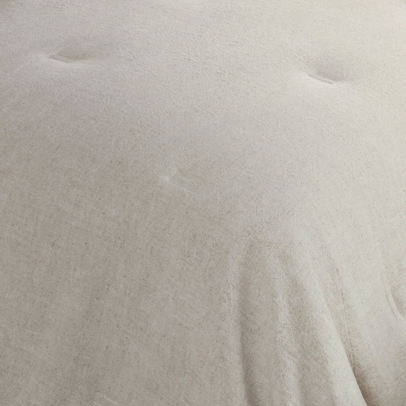 Natural comforter sham fabric close-up, solid beige textured weave
