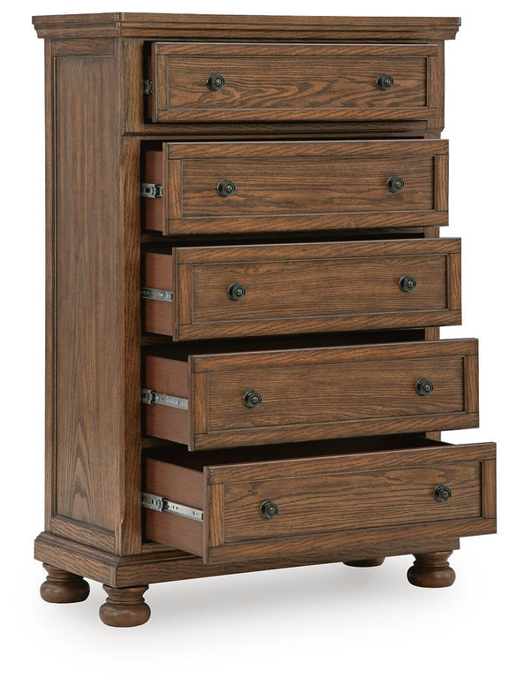 Zackaryn warm brown wood five-drawer chest with partially open drawers and metal knobs.
