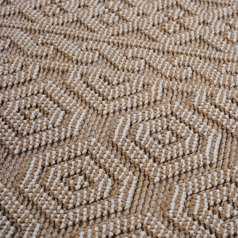 Geometric indoor/outdoor area rug, light brown and white pile texture close-up