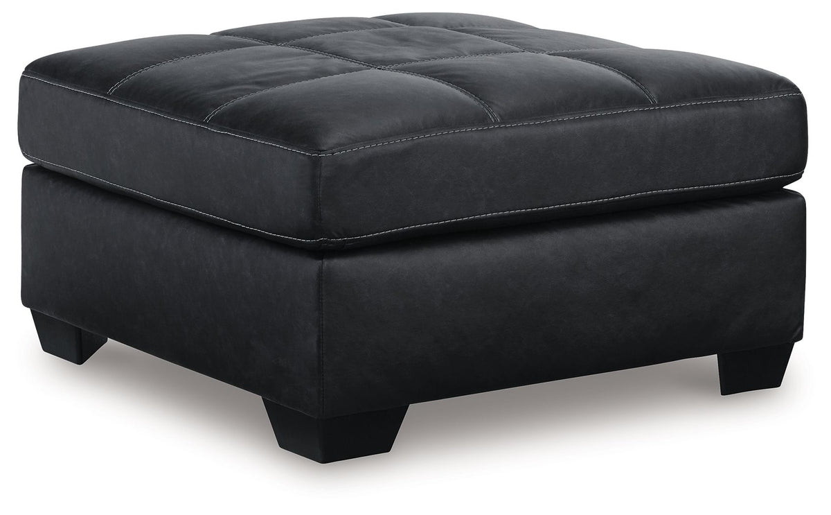 Dark oversized accent ottoman with tufted top and square padded sides