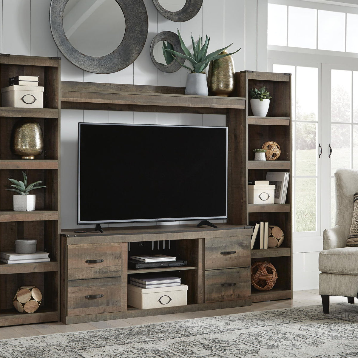 Dark brown entertainment center with TV stand, shelves, and unlit fireplace cabinet