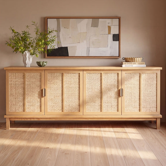 Natural sideboard with woven rattan doors, dark metal pulls, and raised wooden base