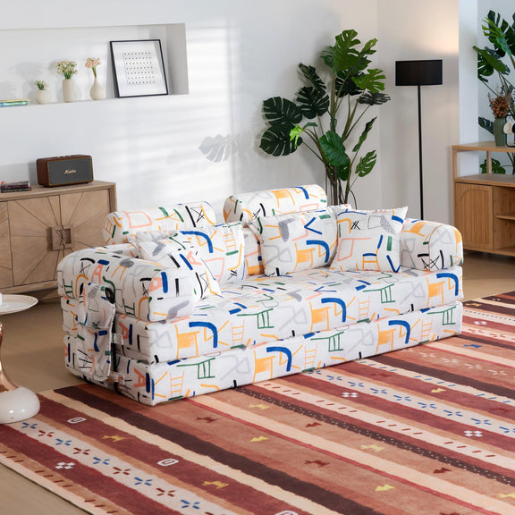 White sleeper sofa bed with colorful icon-pattern upholstery, angled view on seat