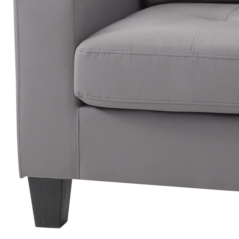 Light gray upholstered accent chair with padded armrests and stitched seat