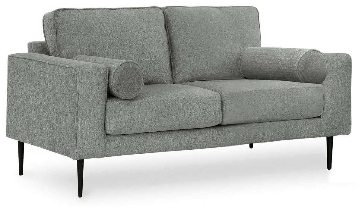 Charcoal gray upholstered loveseat with rolled arms, tufted arm cushions, and tapered legs