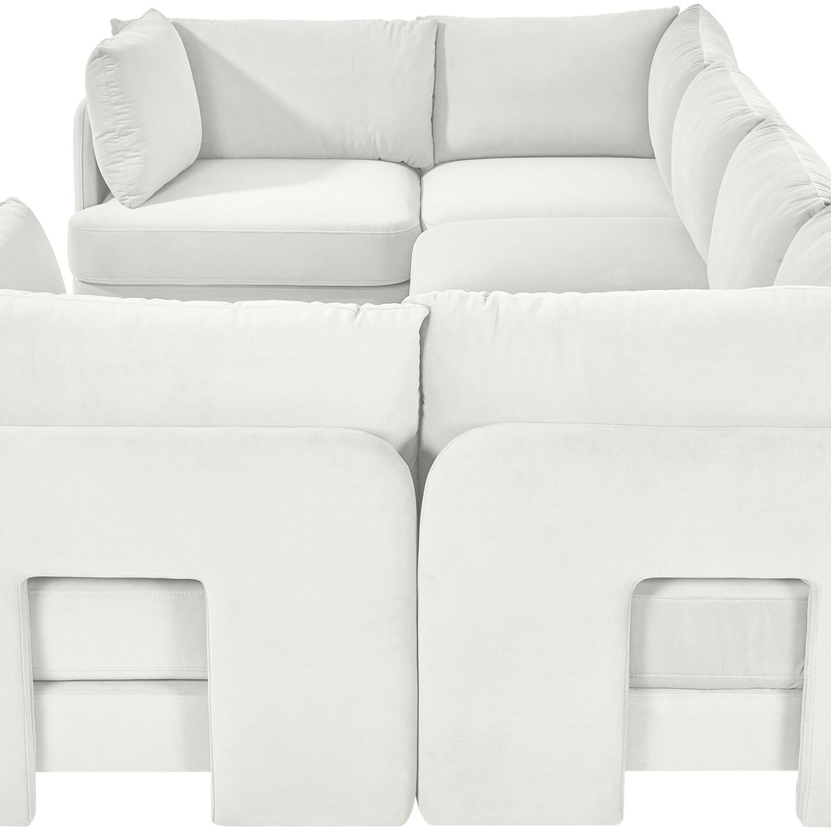 White velvet U-shaped sectional sofa with rounded back and padded armrests