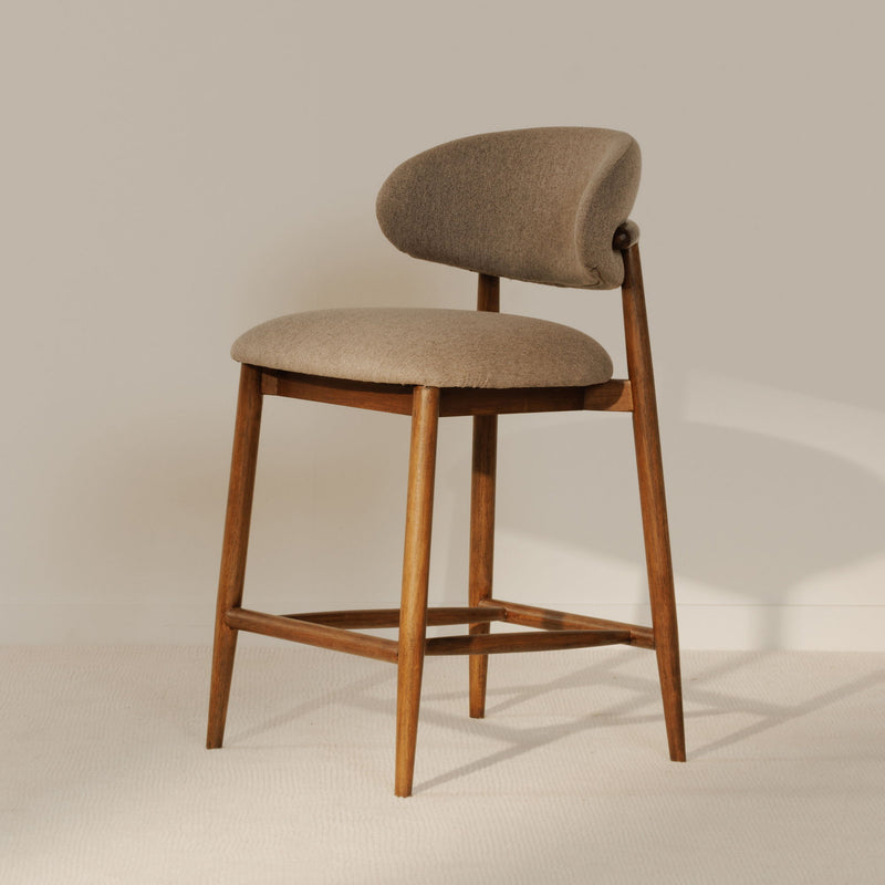 Counter stool with curved backrest, beige upholstery and light brown wooden legs