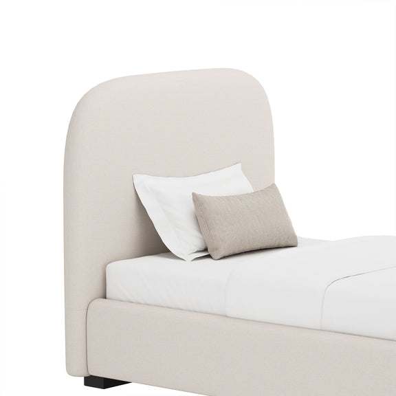 Beige upholstered bed with rounded headboard and smooth rounded edge frame