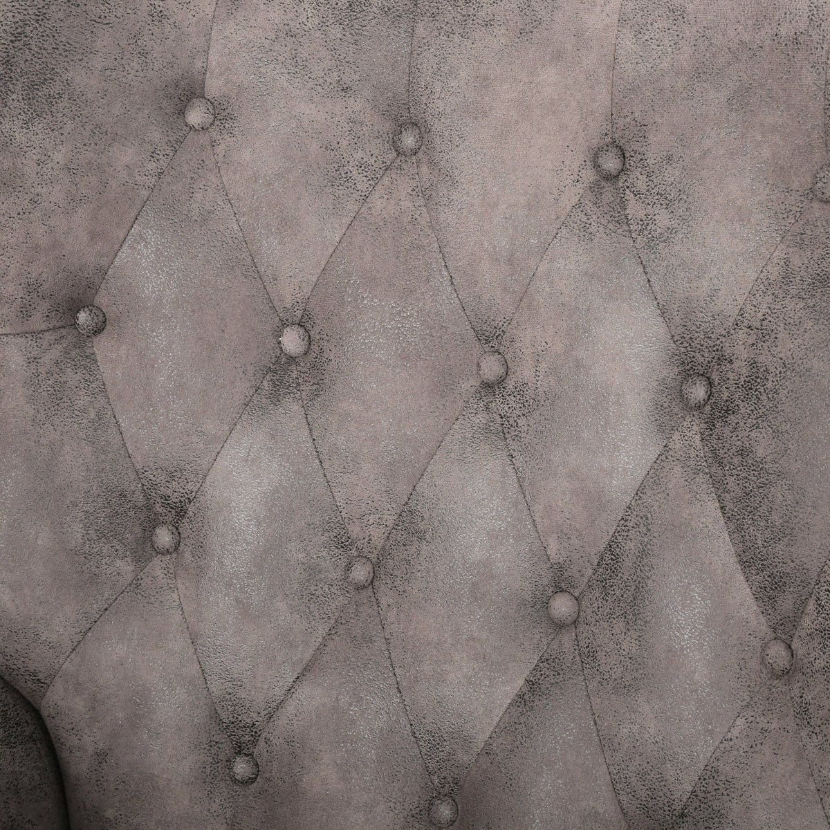 Gray recliner chair upholstery close-up with diamond tufting and button details