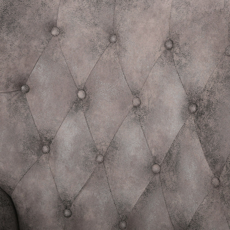 Gray recliner chair upholstery close-up with diamond tufting and button details