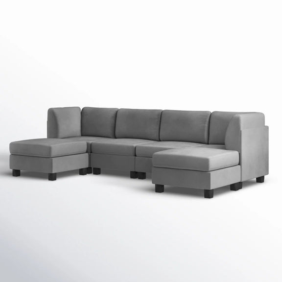 Gray upholstered modular sectional sofa with chaise and cushioned ottoman