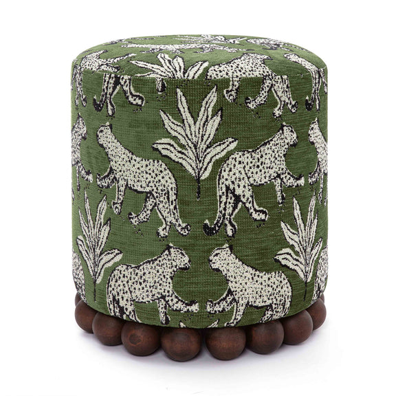 Dark green fabric ottoman with white animal pattern and dark wood ball base.