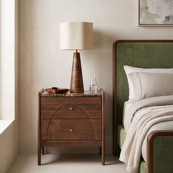 Dark brown mango wood nightstand with two drawers and brass knobs, styled in room