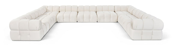 White velvet upholstered sectional sofa with tufted cushions and rounded arm sections