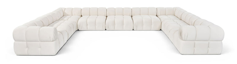 White velvet upholstered sectional sofa with tufted cushions and rounded arm sections