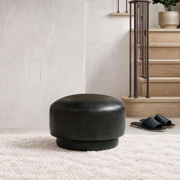 Black mushroom ottoman footstool with rounded top and low, wide base