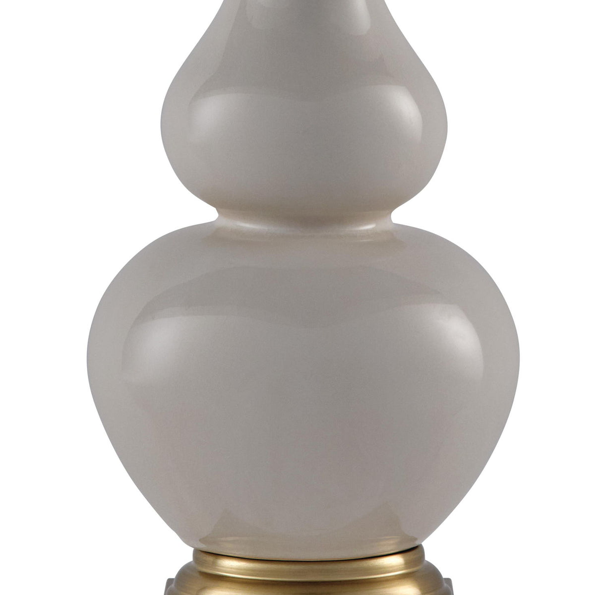 Close-up ceramic table lamp with gray finish, gold base ring, and cream shade