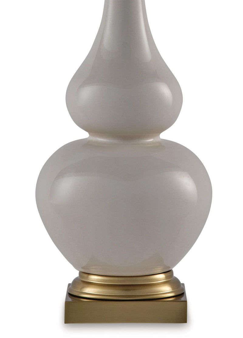 Close-up ceramic table lamp with gray finish, gold base ring, and cream shade