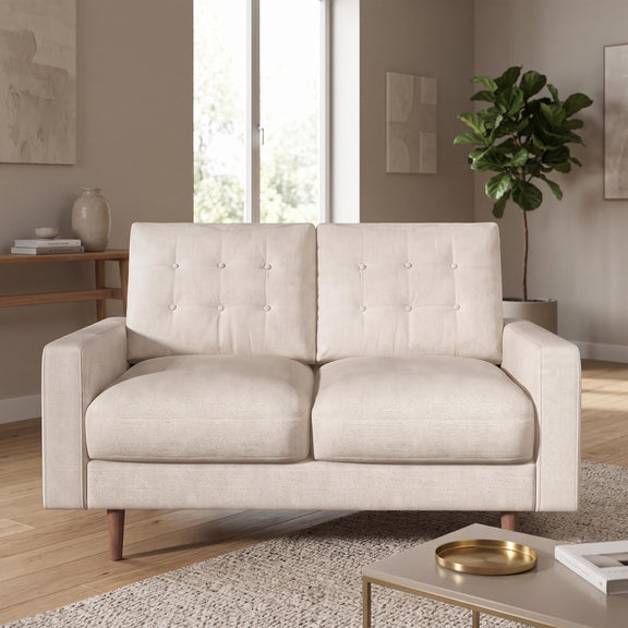 Beige two-seat loveseat sofa with tufted back cushions and tapered wooden legs