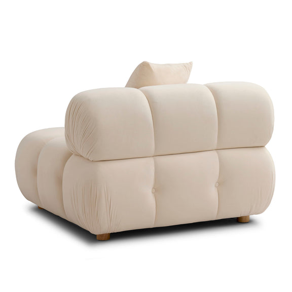 Cream corner chair with gathered upholstery, two pillows, and tufted back cushions