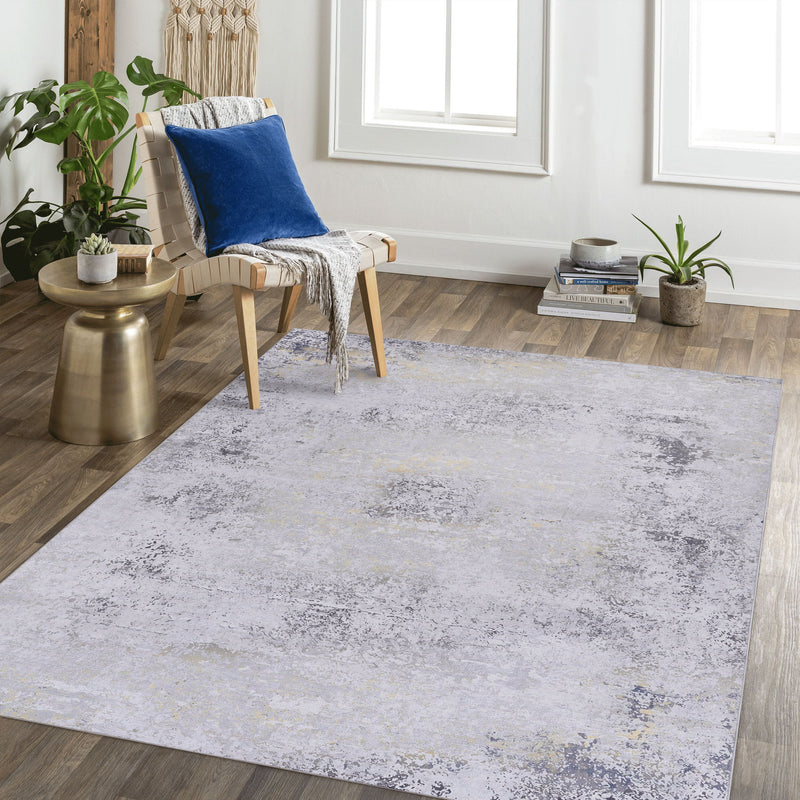 Gray area rug with faded abstract pattern and gold flecks, large size