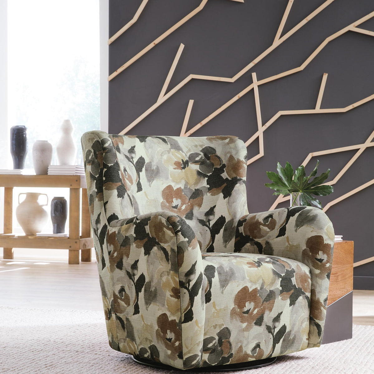 Floral swivel accent chair with green, brown, and cream upholstered arms and seat