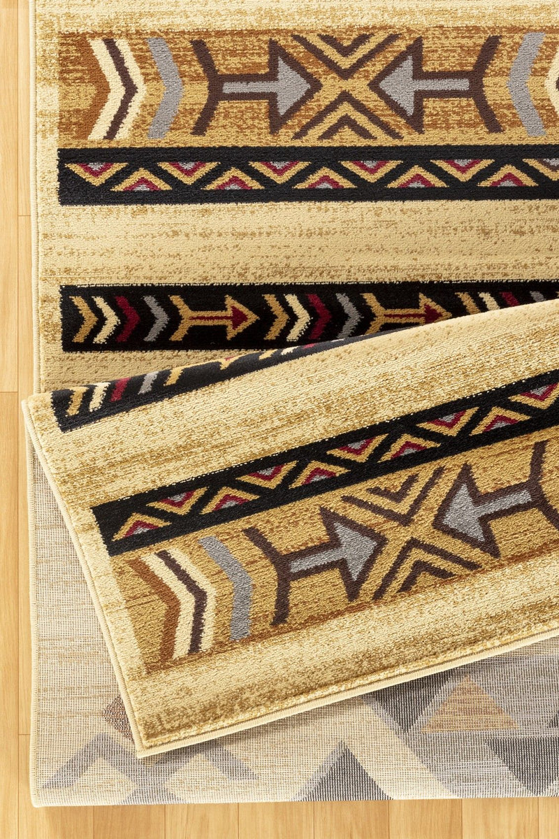 Beige area rug with layered geometric borders and arrow motifs, shown overlapping