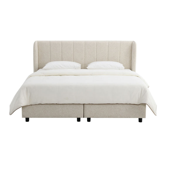 Beige upholstered platform bed with tufted headboard and fitted mattress