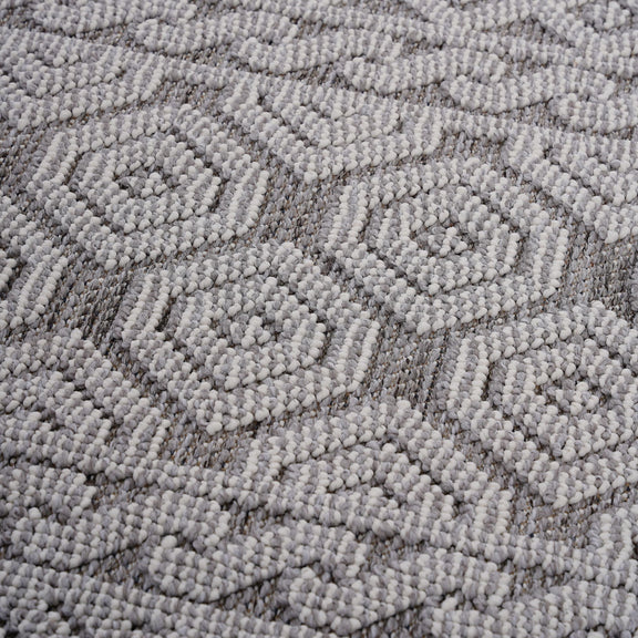 Gray-and-white geometric area rug with repeating diamond pattern in raised loop texture