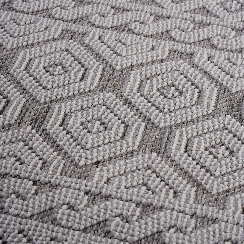 Gray-and-white geometric area rug with repeating diamond pattern in raised loop texture