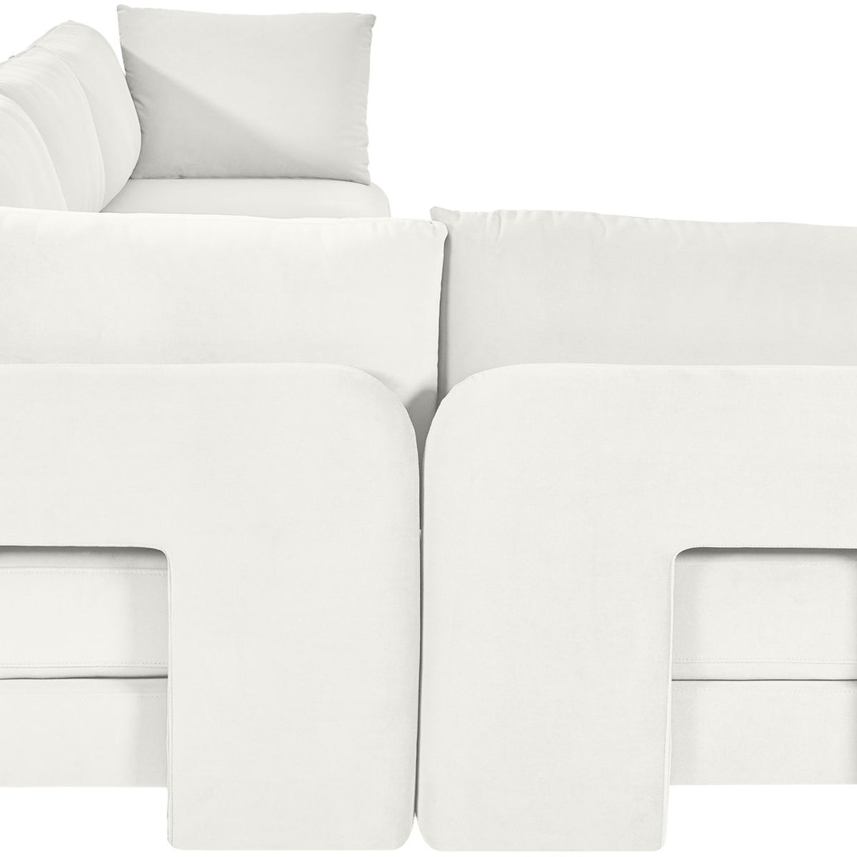 White velvet L-shaped sectional sofa with padded backrests and chaise seating