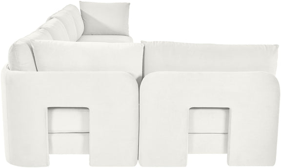 White velvet L-shaped sectional sofa with padded backrests and chaise seating