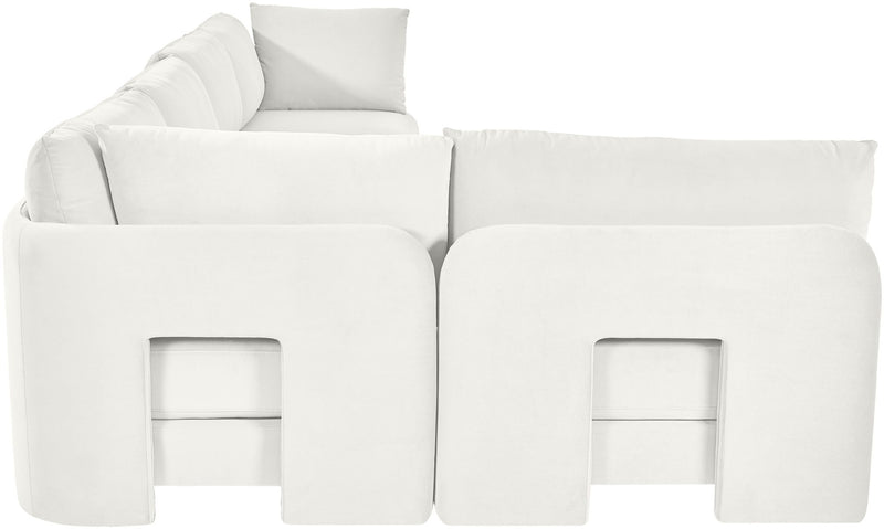 White velvet L-shaped sectional sofa with padded backrests and chaise seating