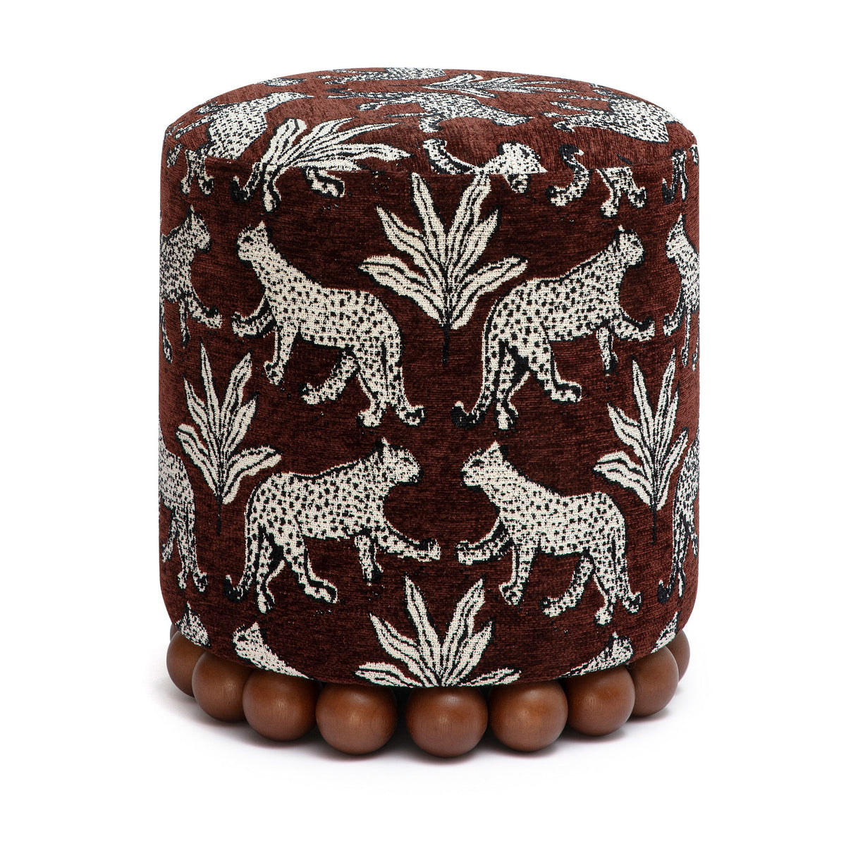 Brown animal-print fabric ottoman with zebra and leaf pattern and bead foot trim