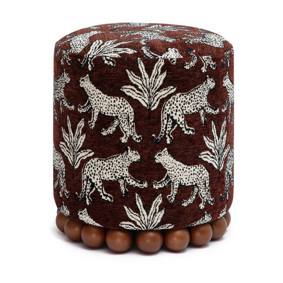 Brown animal-print fabric ottoman with zebra and leaf pattern and bead foot trim