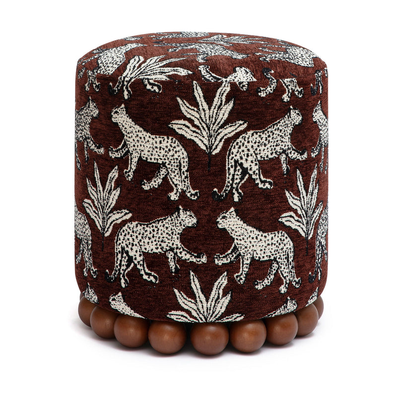 Brown animal-print fabric ottoman with zebra and leaf pattern and bead foot trim