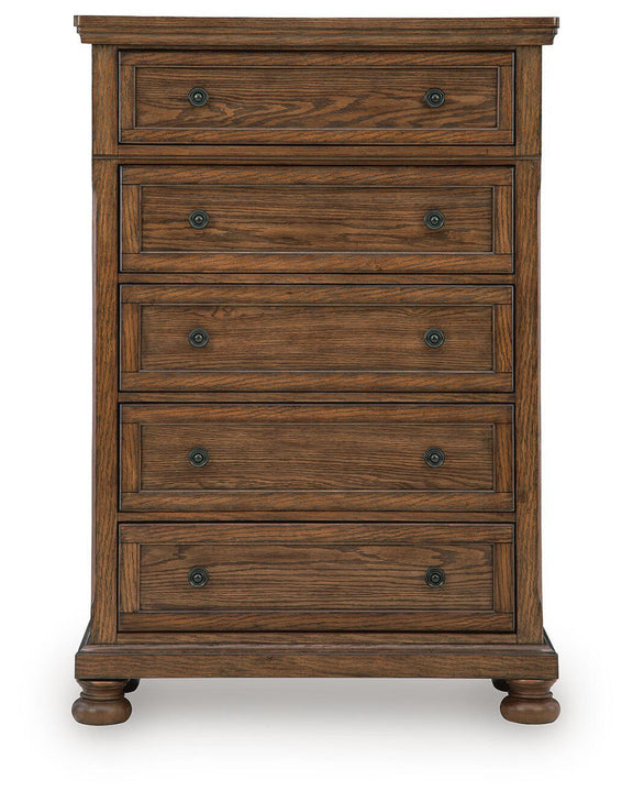 Zackaryn warm brown wood five-drawer chest with decorative molding and round metal knobs, bun feet.