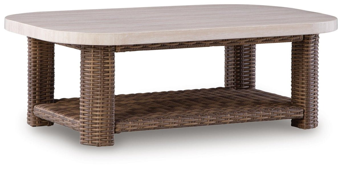 Rectangular wicker cocktail table with beige tabletop and brown woven lower shelf