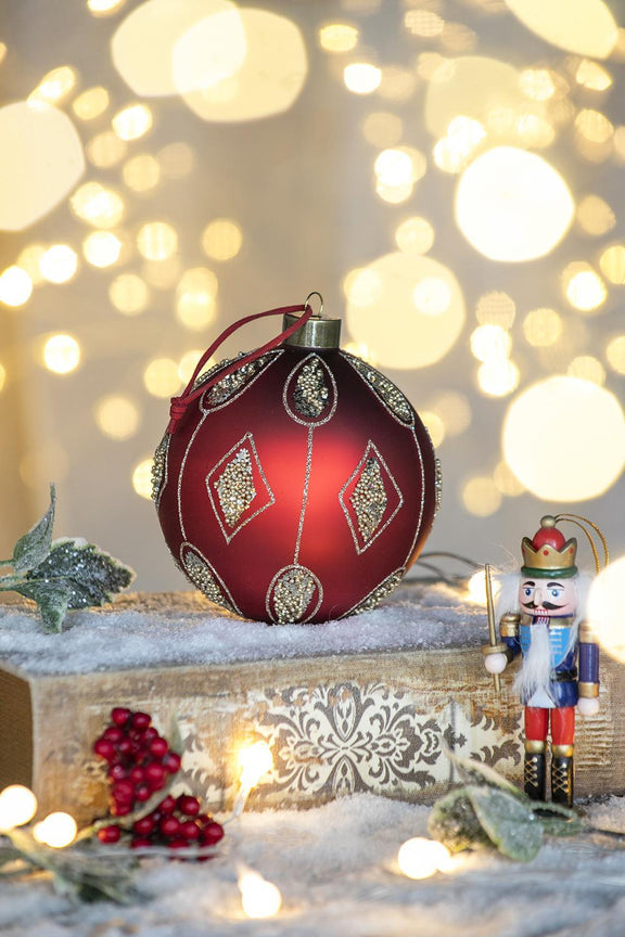 Red decorative hanging Christmas ball ornament with gold geometric and beaded details