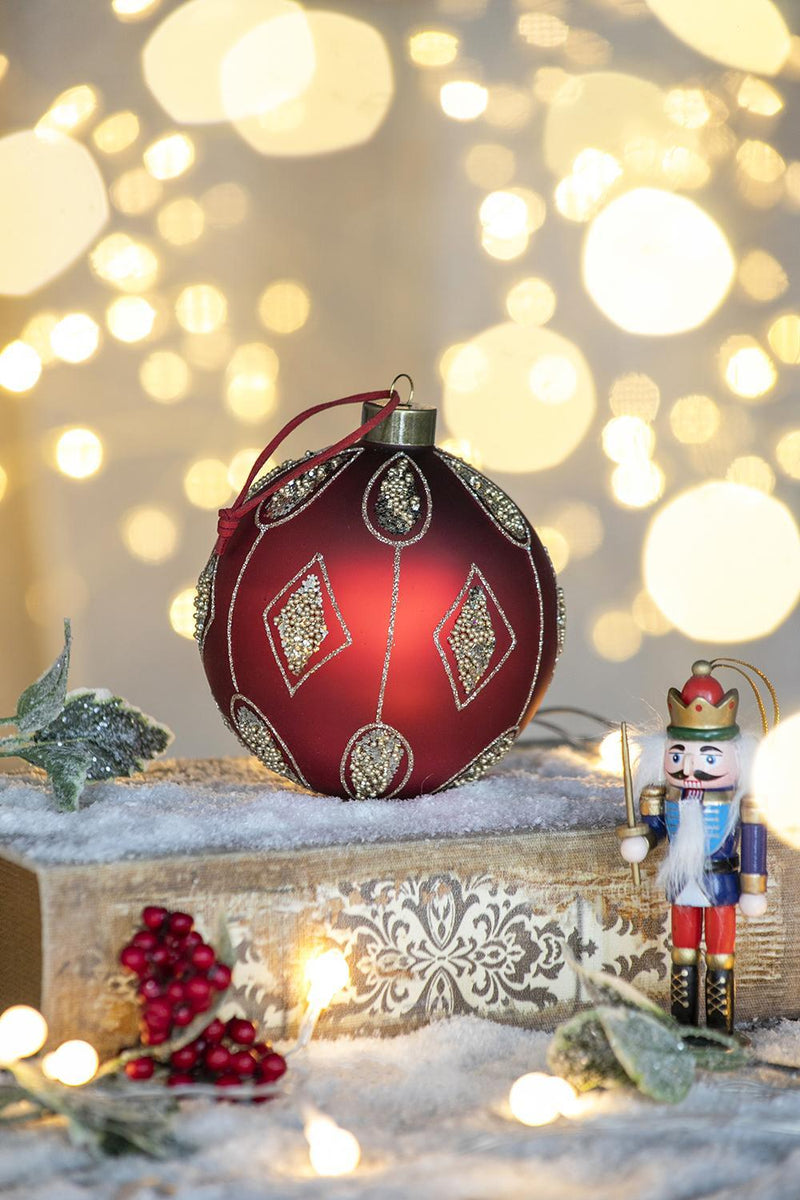 Red decorative hanging Christmas ball ornament with gold geometric and beaded details