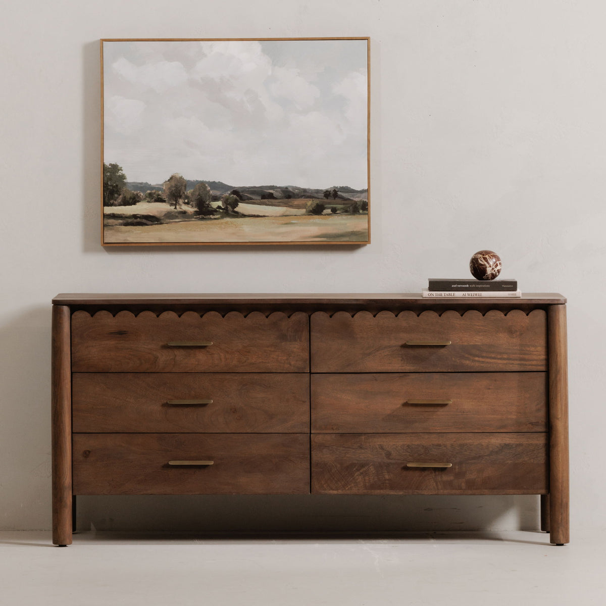 Vintage brown dresser with four drawers, scalloped trim, and gold bar pulls