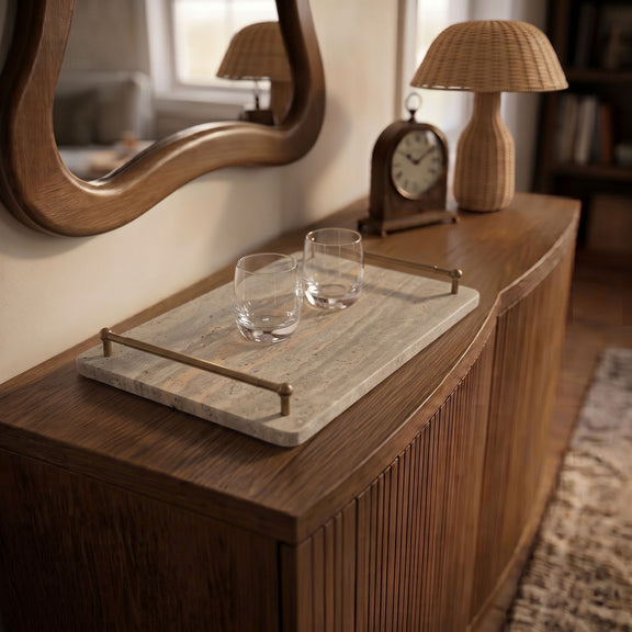 Beige travertine tray on vanity with two clear glasses and four metal corner posts.
