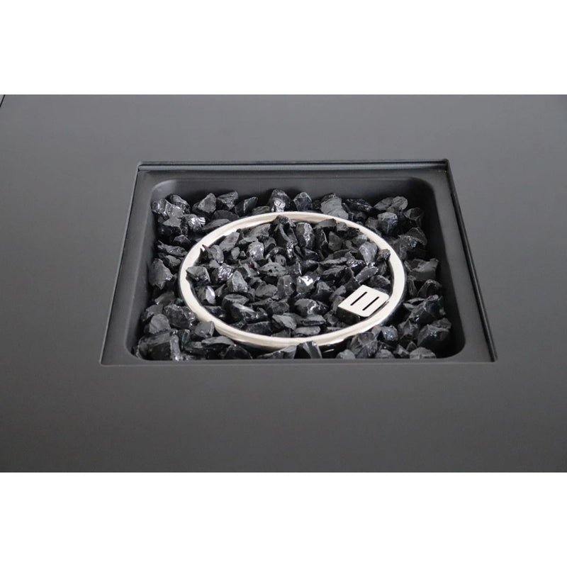 Open fire pit table showing black lava rocks in the fire bowl