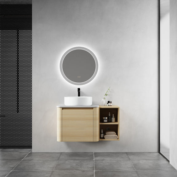 Bathroom vanity with white vessel sink and light-wood cabinet with open side shelf and door.