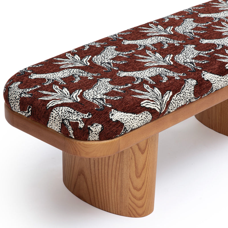 Leopard jacquard bench close-up: dark brown fabric with white animal print, light wood base