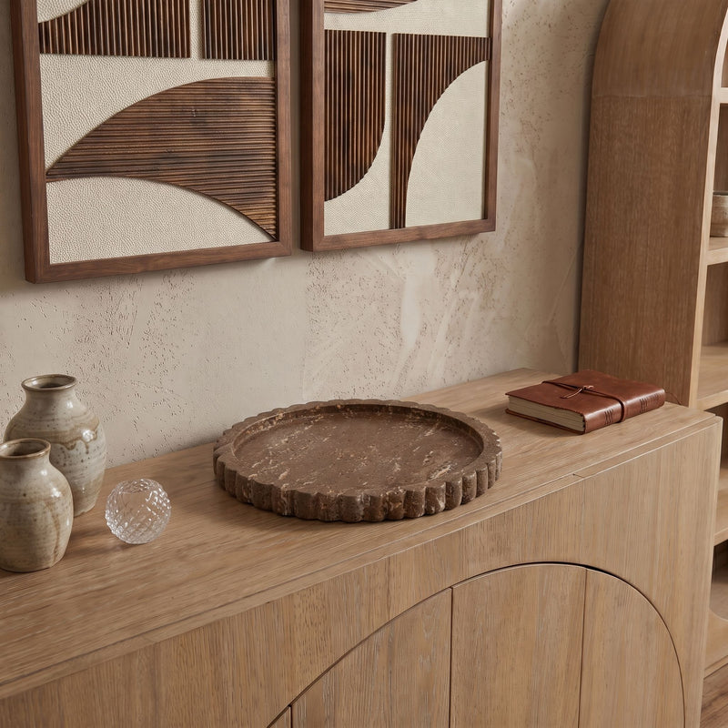 Travertine tray on wooden shelf with scalloped rim, round speckled top.