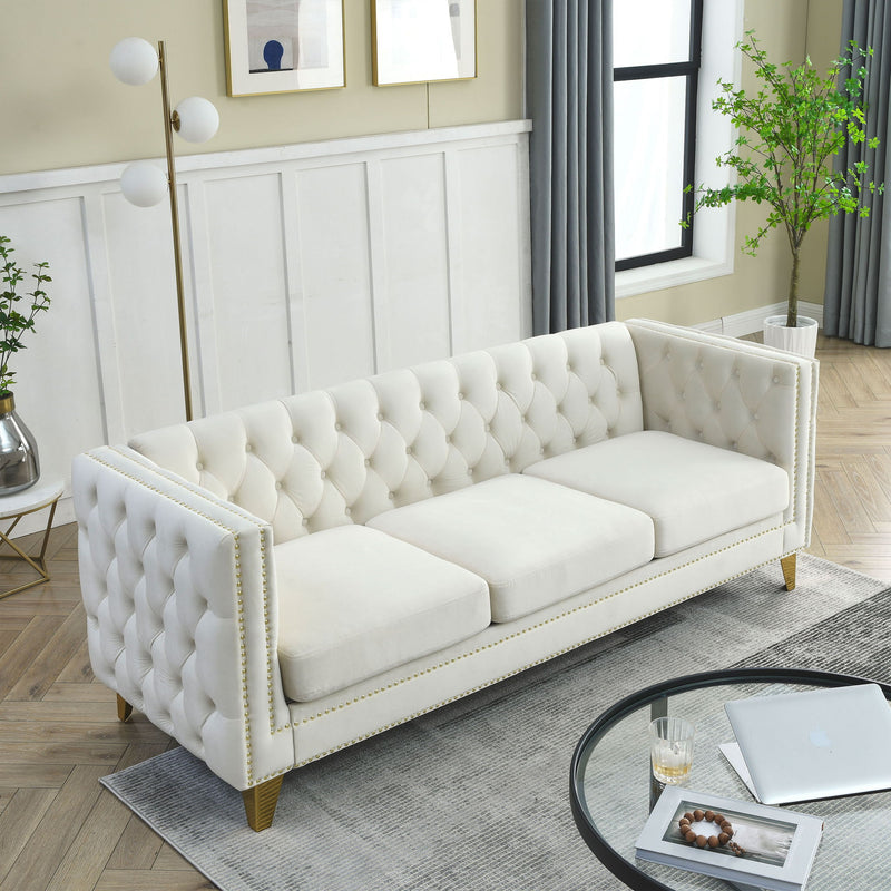 White button-tufted sofa with diamond tufting, nailhead trim, and gold legs